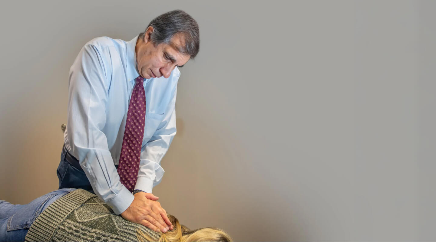 Oak Creek chiropractor Dr Gavric adjusting patients back