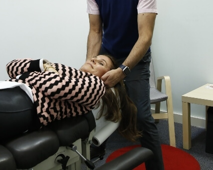 Female patient getting her neck adjusted