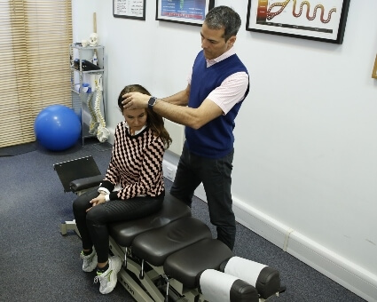 Chiropractor performing a cranial exam
