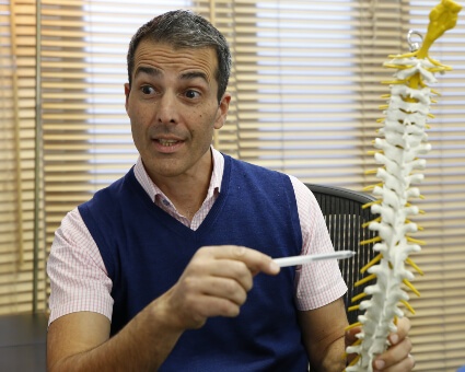 East Horsley chiropractor Julian Keel pointing at spine