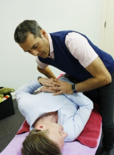 East Horsley chiropractor adjusting a female patient