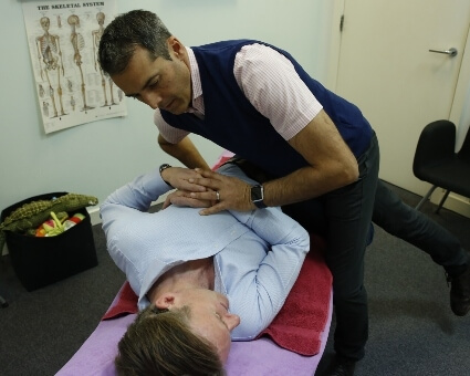 Female patient receiving a chiropractic adjustment