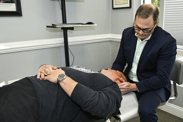 Myrtle Beach chiropractor Dr. Levy adjusting patient's neck