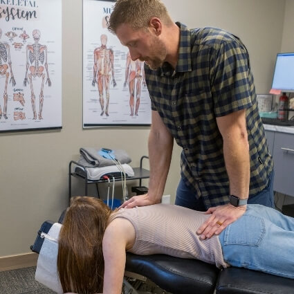 woman having back adjusted