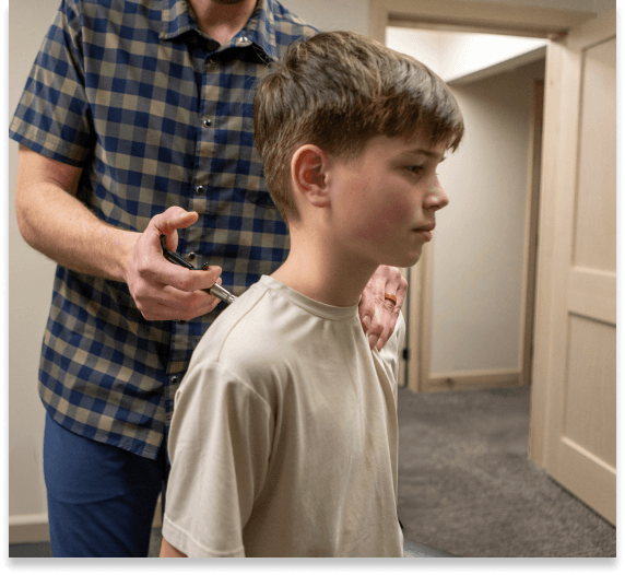 Key City Chiropractic & Acupuncture patient having activator adjustment on their neck