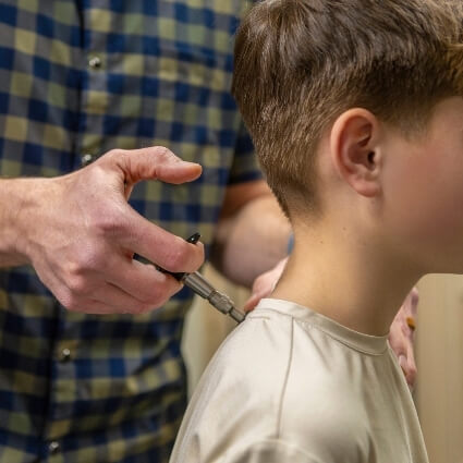 activator adjustment on persons neck