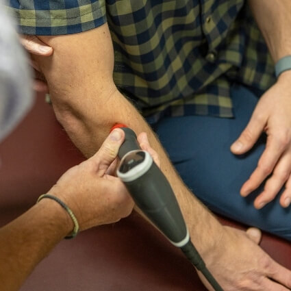 shockwave therapy on Key City Chiropractic & Acupuncture patients arm
