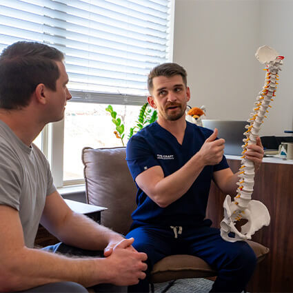 Frisco Chiropractor Dr. Ryan discussing spine care with patient