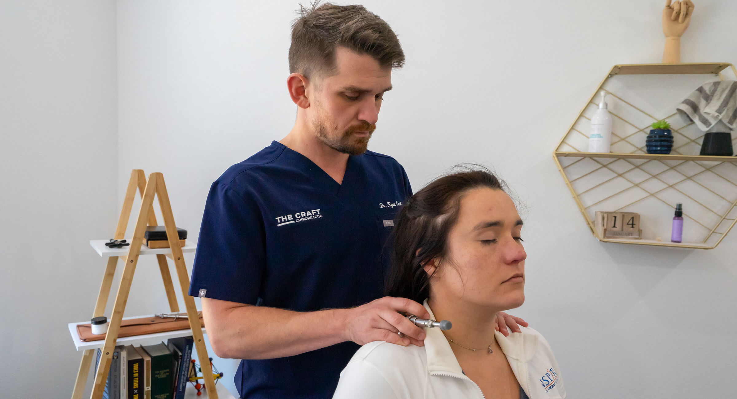 Frisco Chiropractor Dr. Ryan pressing on woman's shoulders