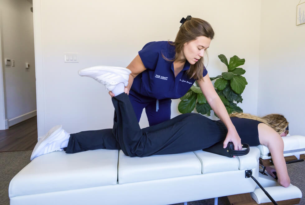 Frisco Chiropractor Dr. Jenni working with female patient