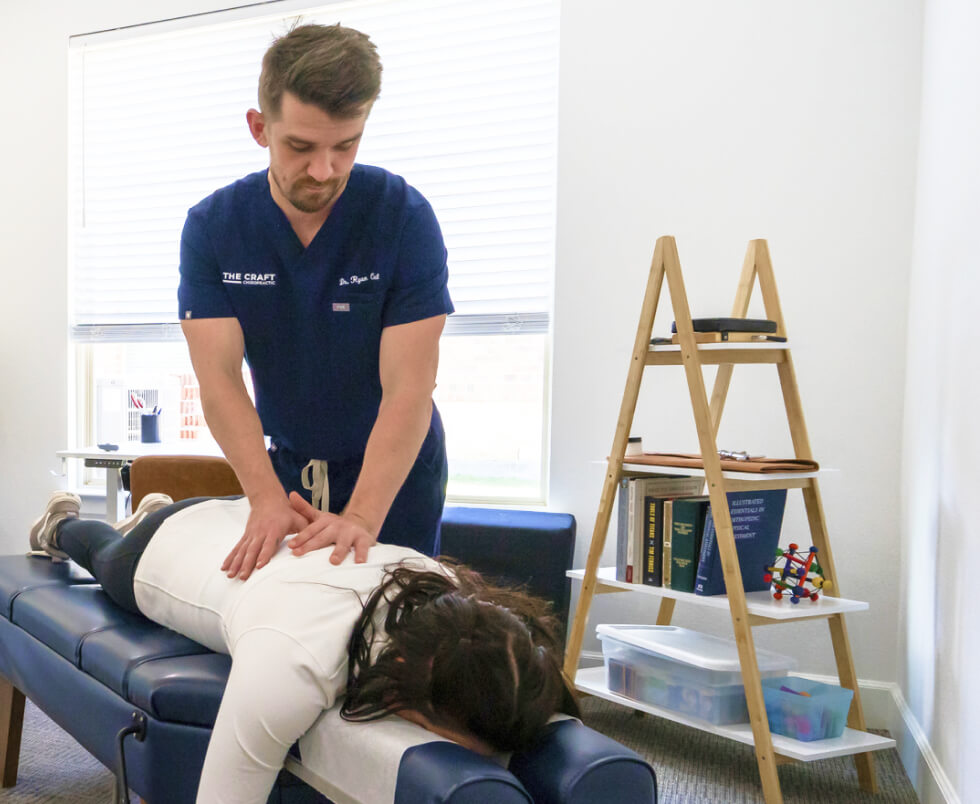 Chiropractor adjusting patient