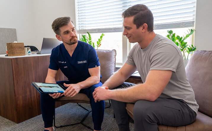 Chiropractor talking to patient