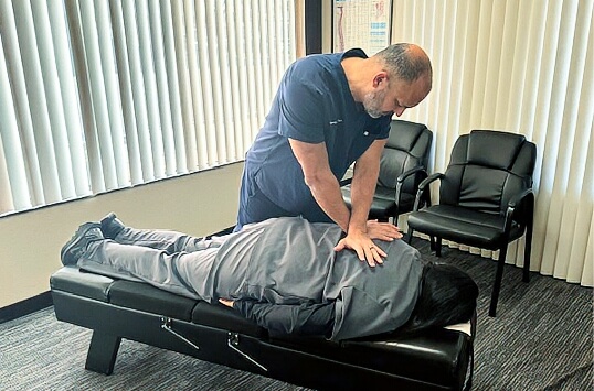 doctor pressing on back