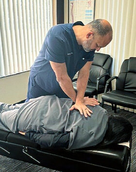 doctor pressing on back