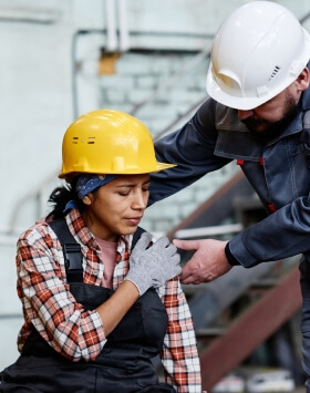 worker helping other worker with shoulder pain