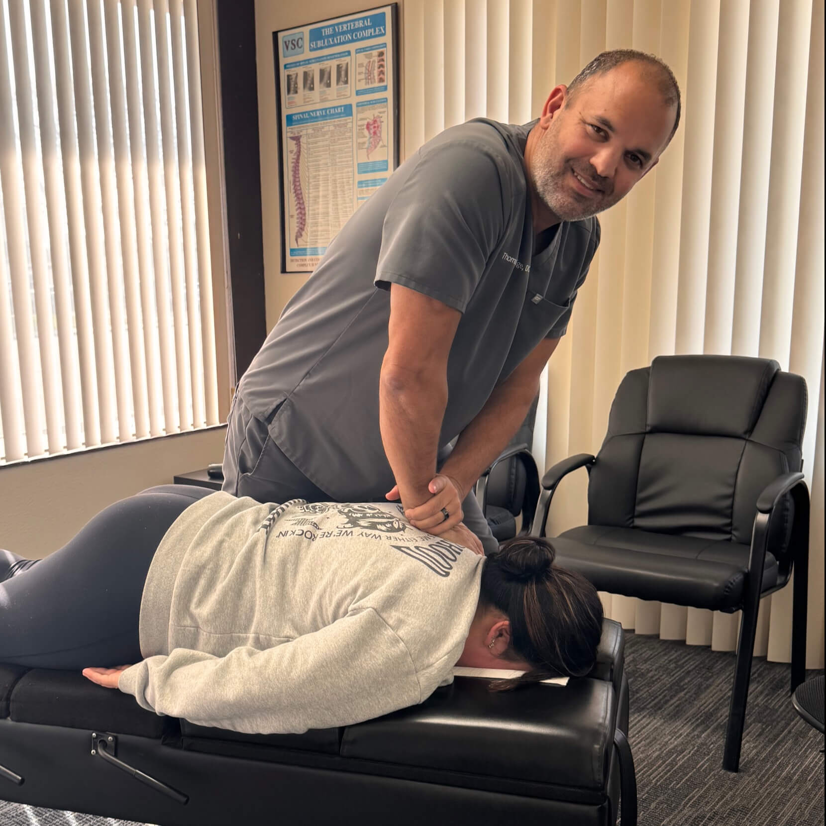Dr. Thomas adjusting patient