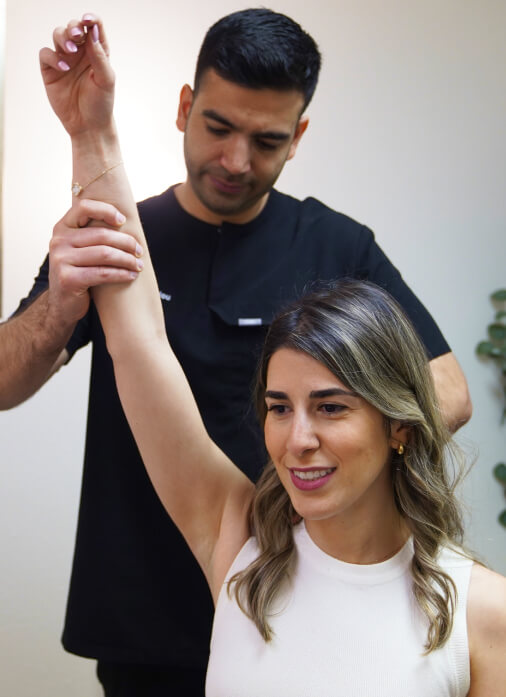 Costa Mesa Chiropractor Dr. Khodayar holding woman's arm