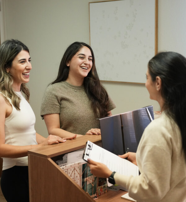 woman laughing at reception desk