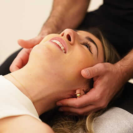 Costa Mesa patient receiving a chiropractic neck adjustment