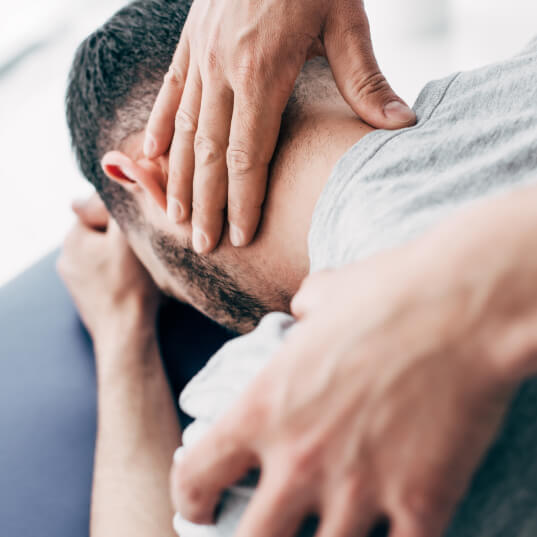 man having neck adjusted
