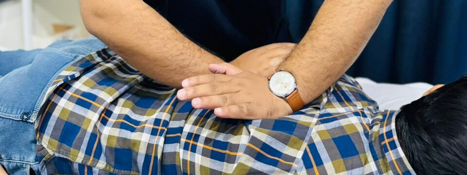Cork chiropractor adjusting a patient's back