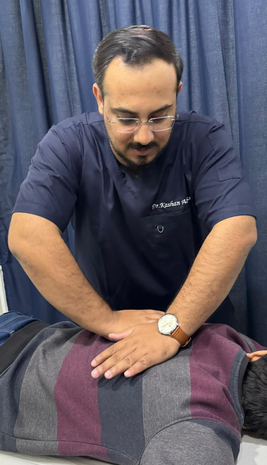 Cork chiropractor Dr. Abbas assisting adjusting a male patient