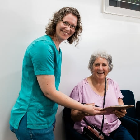 Staff member assisting patient with paperwork
