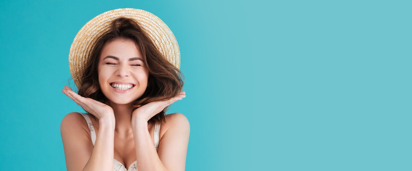 Woman with big smile holding her face
