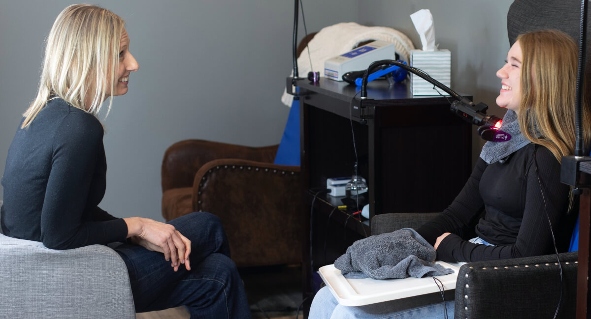 Chiropractor and Burlington patient sharing a laugh together