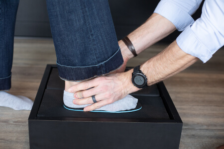 Burlington chiropractor fitting patient for orthotics