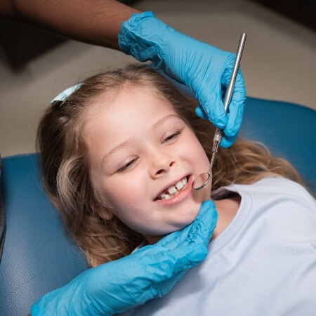 Dentist doing a chekcup on a child