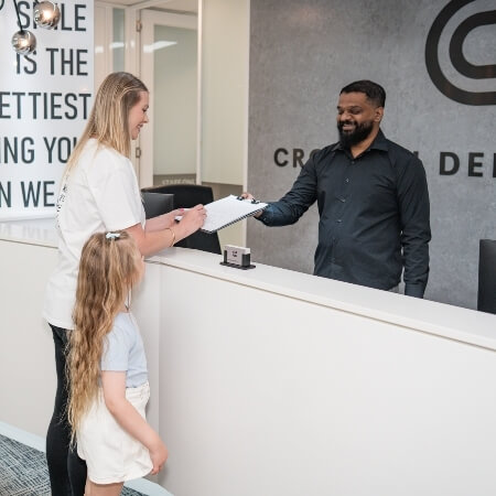 Patients checking in at front desk