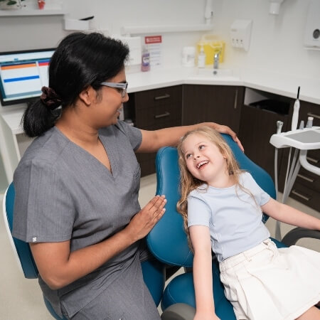 Smiling girl in a dental chair