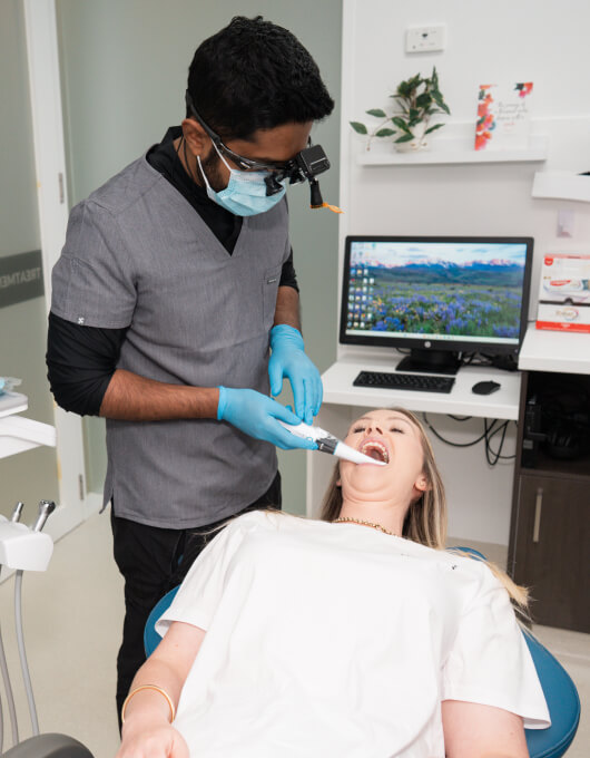 Female patient getting her teeth examined