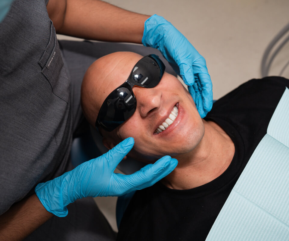 Smiling man receiving a dental exam