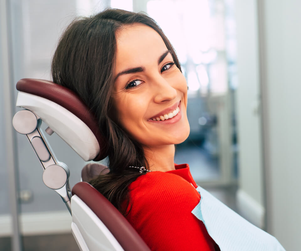 Smiling woman sitting on a dental chair