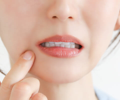 Woman in pain from teeth grinding