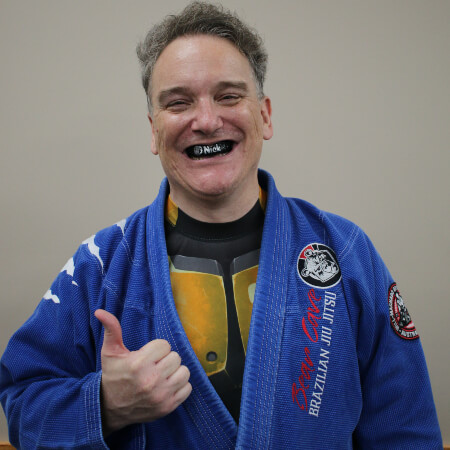 Smiling man wearing mouthguard