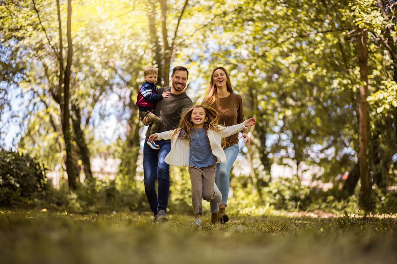 happy family walking together on a trail outdoors