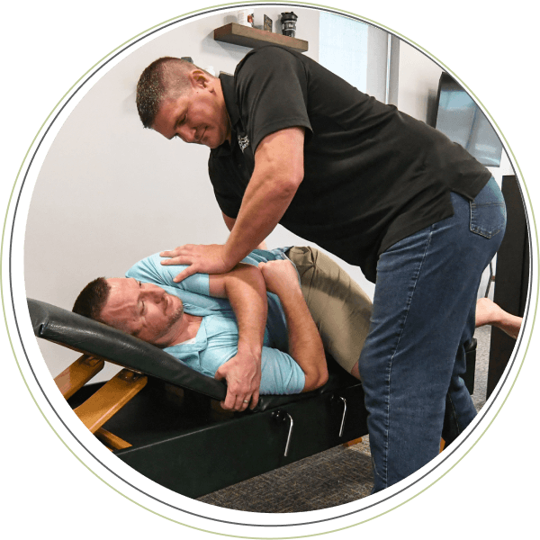 Dr. Justin adjusting patient