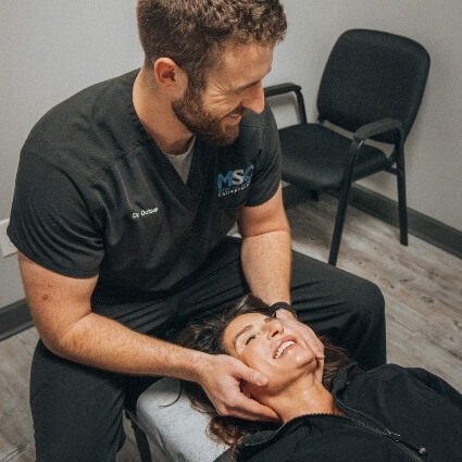 Dr Dotson adjusting womans neck