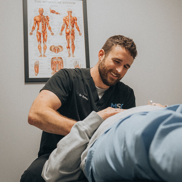 Hendersonville chiropractor Dr Garrin adjusting patient laying on table