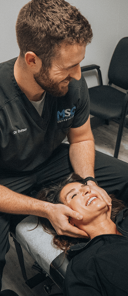 Hendersonville chiropractor Dr Garrin adjusting womans neck