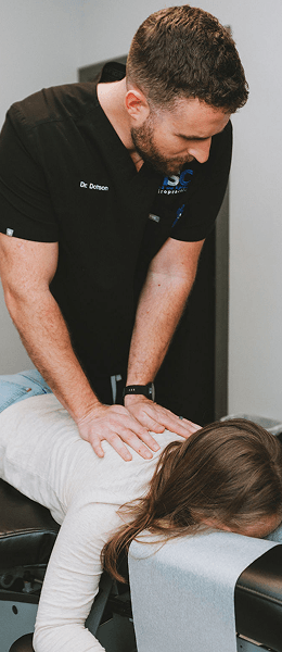 Mind and Spine Chiropractic patient laying on table having back adjusted