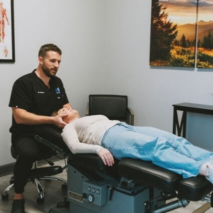 Hendersonville chiropractor Dr Dotson adjusting patients neck