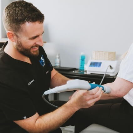 soft tissue therapy on womans elbow