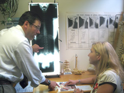 Dr. Phelps showing a patient her x-rays during the second visit Report of Findings