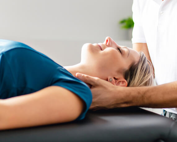 woman having neck adjusted