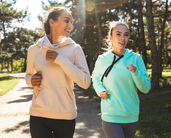 two young women running outdoors