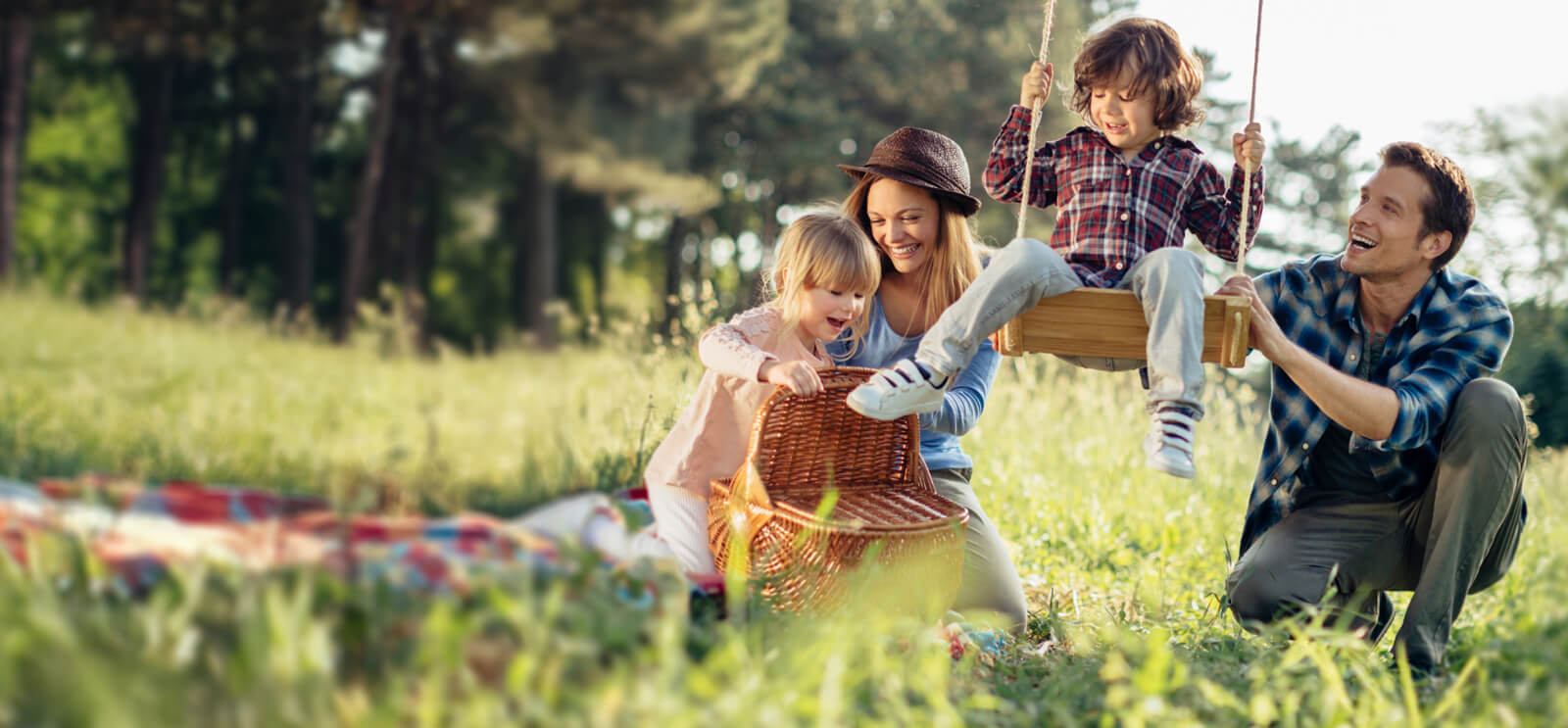 family of 4 having a picnic outdoors